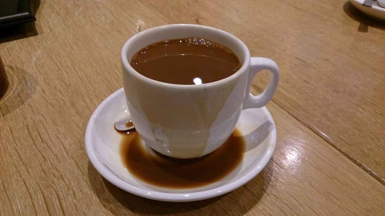 A cup of black coffee on a saucer