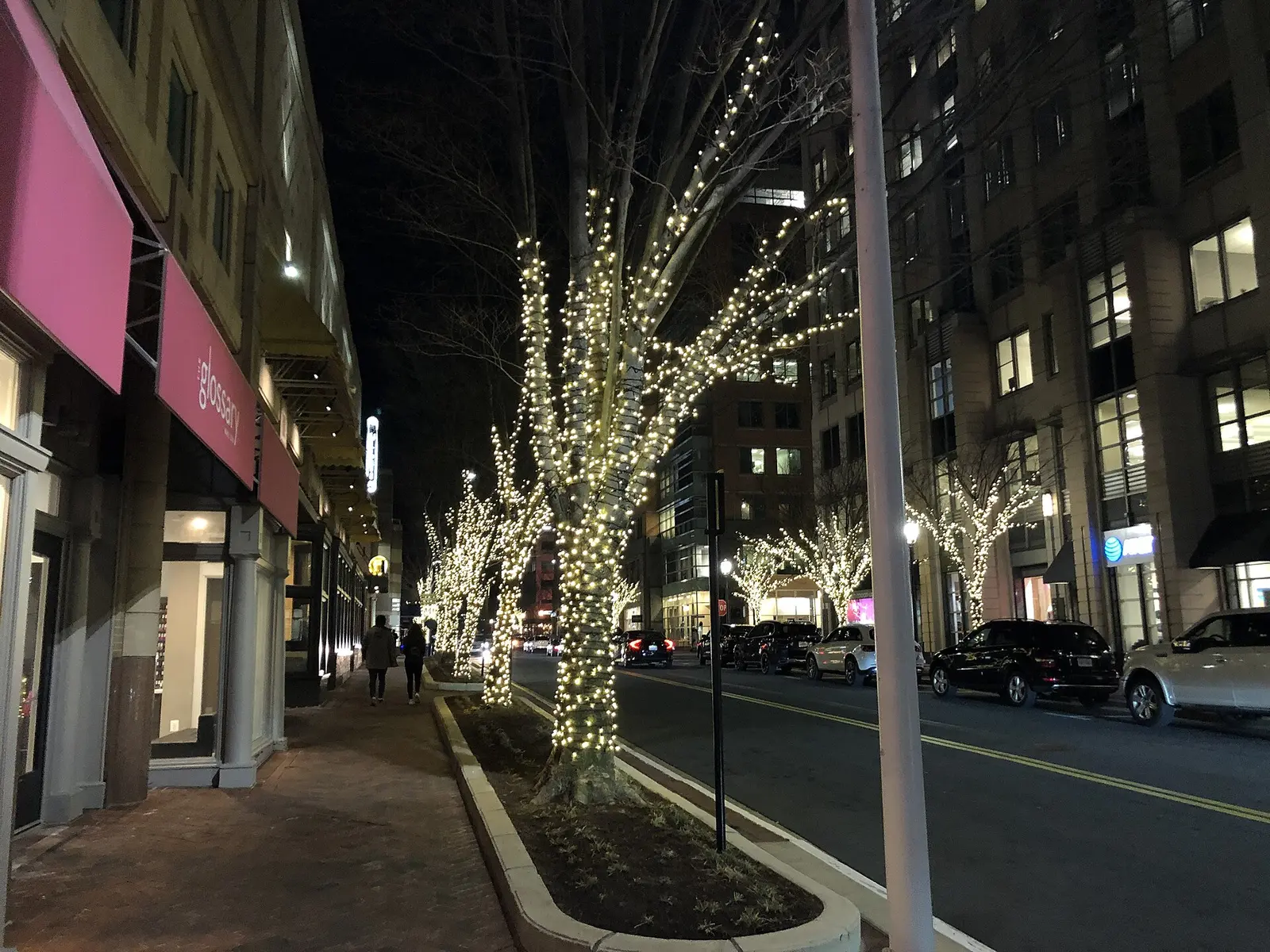 Trees wrapped in lights along Library Street at Freedom Drive in Reston Town Center at night