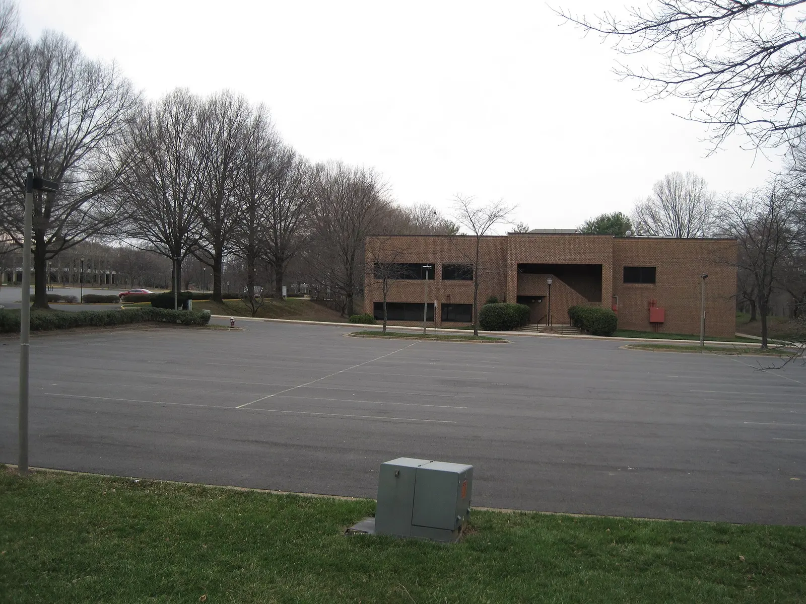 Wiehle Avenue at Isaac Newton Square, at the southern edge of the Tall Oaks area, with office buildings set back behind the trees