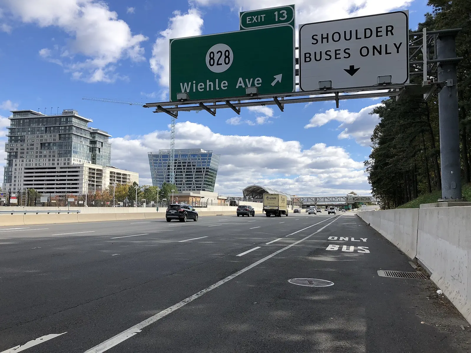 The Dulles Toll Road eastbound at Exit 13 for Wiehle Avenue in Reston, with the shoulder marked for buses